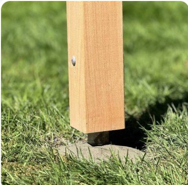 Cedar post on pipe set in a lawn